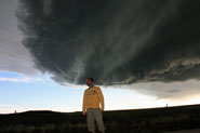 man in front of storm cloud